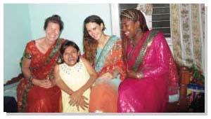 3 people from Britain. They are dressed in Saree